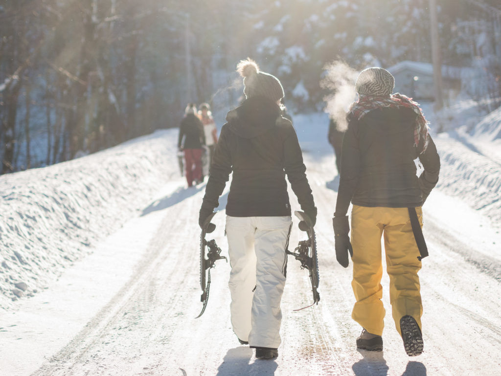 women snowshoeing